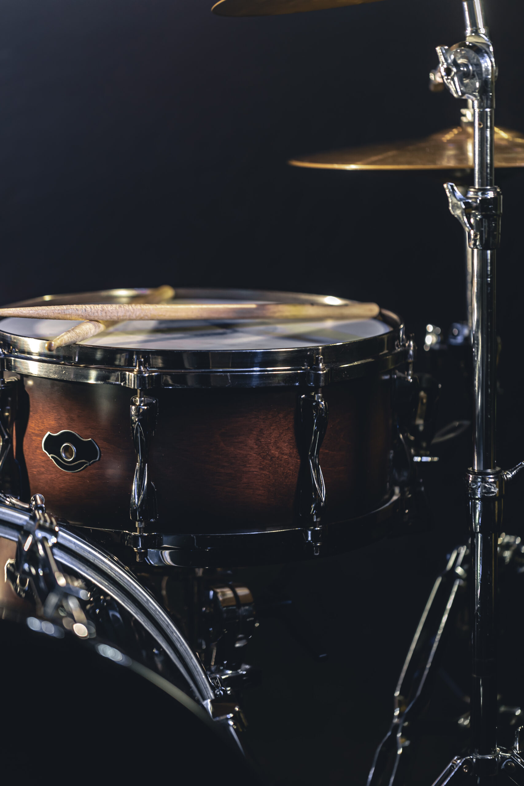 Snare drum on a blurred dark background, part of a drum kit, music concert cncept.